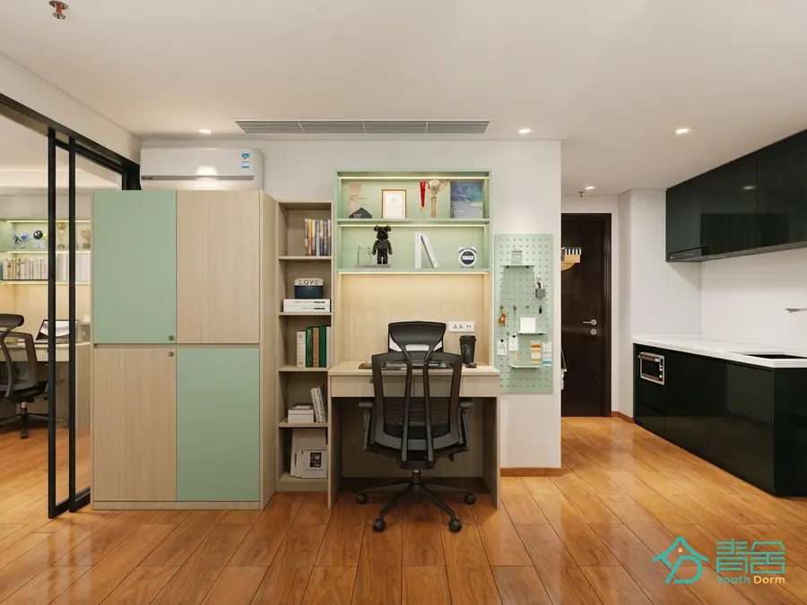 Study and kitchen corner at the Sheung Wan Dorm (Youth Dorm) with desks, shelving and lockers